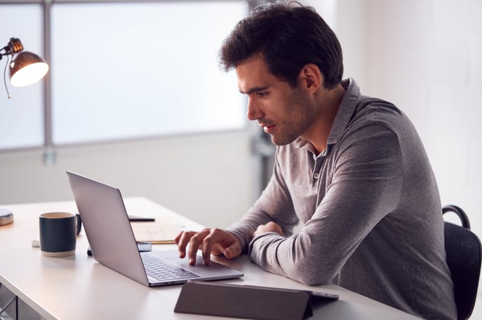 businessman-working-on-laptop-at-desk-in-modern-of-2024-10-19-06-13-45-utc-jpg-1